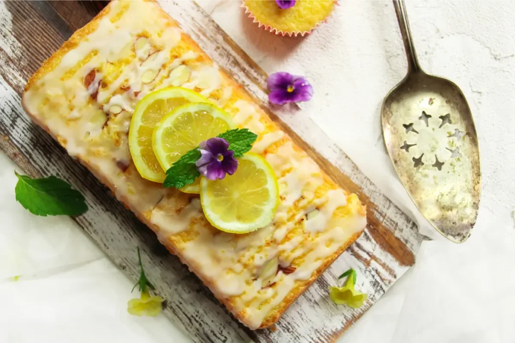 Moist and golden-brown pound cake with visible tender crumb, lightly dusted with powdered sugar