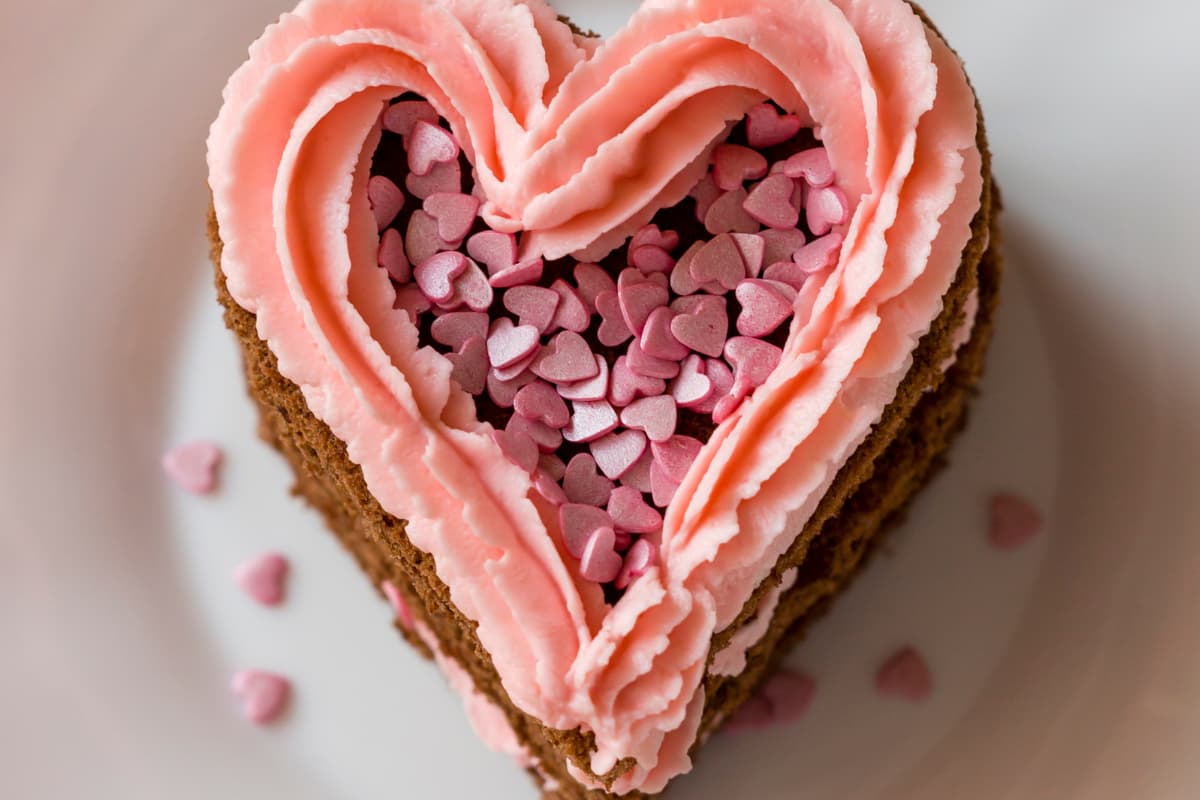 Publix heart-shaped cake decorated with pink and red icing roses and 'I Love You' message.